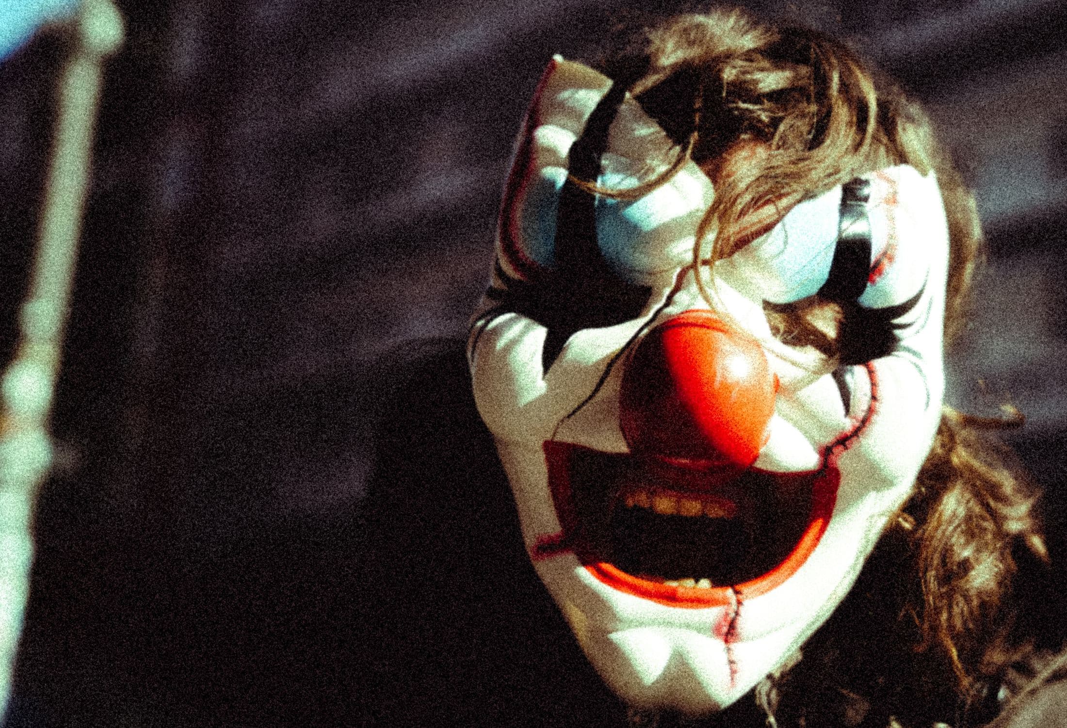 Person in a clown mask, the artwork of We're All Gonna Die